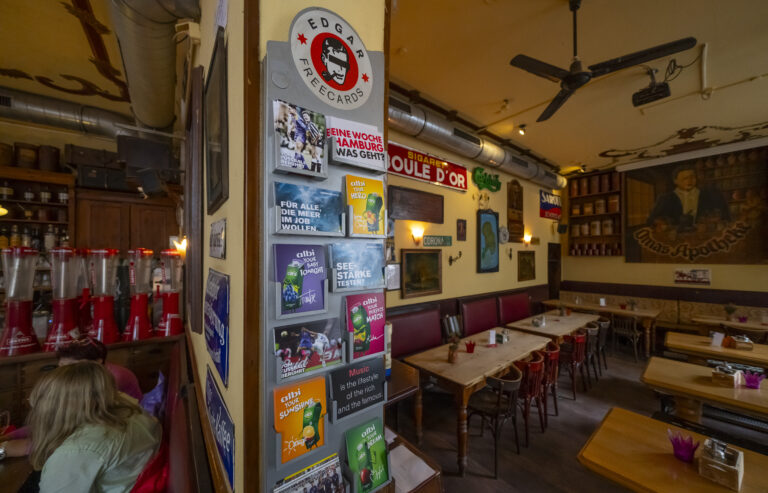 Postkartenständer mit Werbekarten in einem Café